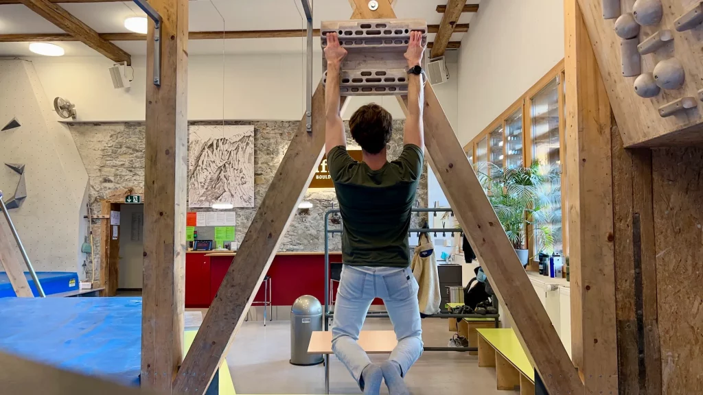 climber hanging on beastmaker 2000 hangboard